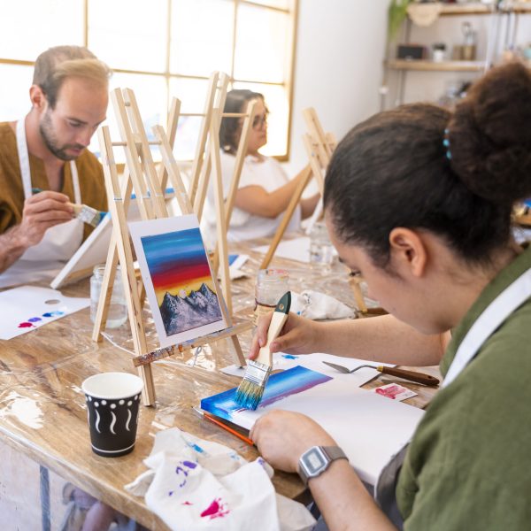 Art and Wine Workshop. Friends painting while tasting different wines.